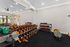 Modern gym weight section featuring free weights, strength-training machines, and rubber flooring.