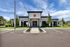Outside view of a modern clubhouse featuring clean architectural lines and lush greenery.