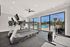 Modern fitness center featuring a variety of cardio machines, including treadmills, ellipticals, and stationary bikes.