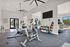 Modern fitness center featuring a variety of cardio machines, including treadmills, ellipticals, and stationary bikes.