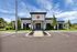 Outside view of a modern clubhouse featuring clean architectural lines and lush greenery.