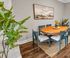 Charming dining area with a natural wood table, stylish chairs, and elegant decor, perfect for intimate gatherings.