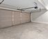 Spacious two-car garage with sleek automatic doors and pristine flooring, ideal for modern living.