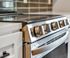 Luxury stainless steel oven with sleek design and modern control knobs, enhancing the contemporary kitchen aesthetic.