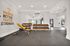 Modern fitness gym with sleek weight equipment and motivational wall art boasting 'Harder, Better, Faster, Stronger.'