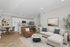 Modern open-concept living area with chic d&eacute;cor, featuring a spacious kitchen and elegant seating arrangements.