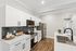 Modern kitchen with sleek white cabinetry, stainless steel appliances, and elegant wood flooring.