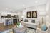 Chic open-plan living room with elegant decor, modern kitchen, cozy seating, and stylish artwork, perfect for contemporary living.