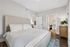 Inviting bedroom with a plush king-sized bed, stylish decor, and warm lighting, offering a cozy and elegant retreat.