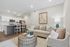 Chic open-concept living area with cozy seating, elegant decor, and a modern kitchen with bar stools. Perfect for comfortable living.
