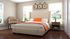 Inviting bedroom with elegant decor, featuring a plush upholstered bed, warm neutral tones, and large windows for natural light.