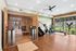 Luxurious home fitness center with modern exercise equipment, expansive windows, and an elegant sauna room.