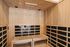 Luxurious wooden sauna room with sleek black panel accents, offering a serene and rejuvenating escape.