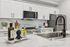 Modern kitchen with sleek white cabinetry, stainless steel appliances, and elegant marble countertops.