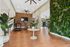 Modern gym interior featuring elegant wooden flooring, lush vertical garden, and top-tier exercise equipment for an energizing workout.