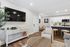 Luxurious open-concept living space with modern decor, sleek kitchen, and cozy seating area, perfect for relaxation and entertaining.