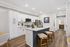 Sleek modern kitchen with stylish white cabinetry, marble countertops, and inviting bar seating, ideal for entertaining and culinary adventures.