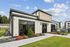 Chic modern building exterior with large windows and lush landscaping, perfect for a thriving community atmosphere.