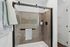Elegant bathroom featuring a modern glass shower with sleek tile walls and stylish fixtures.
