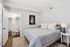 Chic bedroom with cozy bedding, stylish decor, and a spacious walk-in closet.