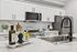 Modern kitchen with sleek white cabinets, stainless steel appliances, and stylish marble countertops featuring elegant decor.