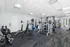 Modern fitness center featuring state-of-the-art gym equipment, spacious workout area, and bright natural lighting.