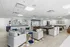 Modern communal lounge with plush seating, elegant decor, and games tables in a bright, open space.