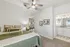 Cozy bedroom with elegant decor featuring a ceiling fan, plush bed with stylish linens, and a modern en-suite bathroom with granite countertops.