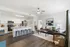 Bright and modern open-concept living area with sleek kitchen, cozy seating, and stylish decor accentuating the inviting space.