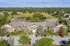 Charming apartment complex surrounded by lush greenery and scenic views, featuring ample parking and inviting entryway.