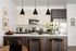 Chic modern kitchen with a sleek island, stylish pendant lighting, stainless steel appliances, and elegant decor accents.