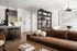 Chic open-plan living room with a cozy brown sofa, modern kitchen island, and elegant shelving, creating a stylish and inviting atmosphere.