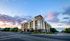 Modern apartment building on a quiet street, with a stunning sunset sky and mountain views, offering luxurious living in a serene environment.
