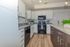 Modern kitchen with sleek granite countertops, stainless steel appliances, and elegant cabinetry in a bright, open space.