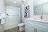 Modern and inviting bathroom featuring a sleek vanity, clean finishes, and a full tub and shower with stylish tile for a bright, refreshed feel.