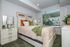 Warm and inviting bedroom with a clean, modern feel, featuring soft finishes, stylish accents, and large windows that bring in plenty of natural light.