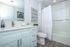 Clean and modern bathroom featuring a sleek vanity, bright finishes, and a full tub and shower designed for comfort and everyday ease.