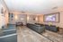 Inviting residential theater room with modern seating, a large screen, and elegant lighting for an enhanced viewing experience.