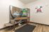 Modern pet-friendly space featuring a Seasons Paw Spa machine, sleek flooring, and vibrant wall art.