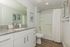 Modern bathroom with elegant granite countertops, sleek fixtures, and contemporary decor.