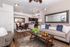 Modern living space featuring a cozy sofa, stylish decor, open dining area, and sleek kitchen perfect for entertaining.