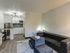Chic apartment interior with modern kitchen, cozy seating area, and elegant decor.