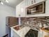 Chic modern kitchen with sleek countertops, stylish backsplash, and stainless steel appliances.