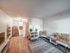 Bright and inviting open-concept living space featuring modern decor, stylish kitchen, and cozy seating area with natural light.