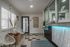 Modern apartment lobby with stylish decor, featuring chic white chairs, a textured accent wall, and soft ambient lighting.