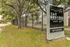 Inviting entrance to The Reserve @ Rye 290 Studios, surrounded by lush greenery and a secure fence.