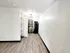 Bright and modern apartment with sleek wood flooring, contemporary lighting, and a compact kitchen with stylish cabinetry.