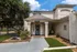 Front entrance of the leasing office at The Reserve at Rye 290 with a covered walkway and landscaped surroundings.