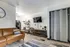Interior living area at The Reserve at Rye 290 with seating, TV, and wood-style flooring.