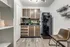 Compact kitchen at The Reserve at Rye 290 with cabinets, refrigerator, and sink.